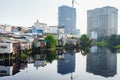 The contrast between slum houses and buildings in Ho Chi Minh city, Vietnam