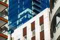 Contrasting architecture with an old building flanked by modern glass high-rises under blue sky Royalty Free Stock Photo