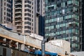 Contrasting architecture with an old building flanked by modern glass high-rises under blue sky Royalty Free Stock Photo