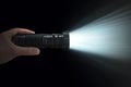 Contrasting brilliance White beam from a black flashlight held dynamically Royalty Free Stock Photo