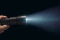 Contrasting brilliance White beam from a black flashlight held dynamically Royalty Free Stock Photo