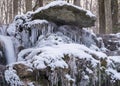 Contrasts of frozen and running water, spring water flows over pieces of limestone, running water freezes to form various Royalty Free Stock Photo