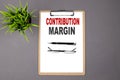 CONTRIBUTION MARGIN on the brown clipboard on the grey background. Business concept