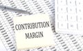 CONTRIBUTION MARGIN - business concept, message on sticker on chart background