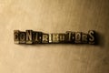 CONTRIBUTORS - close-up of grungy vintage typeset word on metal backdrop