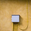 Control electrical box on yellow wall. Royalty Free Stock Photo