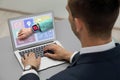 Control kid`s geolocation via smart watch. Man using laptop at table, closeup