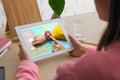 Control kid`s geolocation via smart watch. Woman using tablet at table, closeup