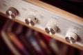 Silver wooden vintage amplifier: Close up of control knobs Royalty Free Stock Photo