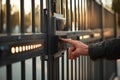 Control panel of a contemporary automated gate features LED indicators and solar cells. A hand is seen pressing buttons Royalty Free Stock Photo