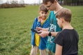 The control panel is in the hands of the boy who controls the drone. Children control a flying quadcopter Royalty Free Stock Photo