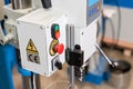 Control panel, large buttons, Emergency stop. New Industrial Iron drill in workshop interior. Closeup on the drill. Tool Royalty Free Stock Photo