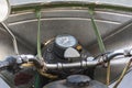 Control panel of an old and rusty green motorcycle. Old analog speedometer and switches on the headlight body. Old batwing is Royalty Free Stock Photo