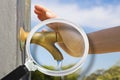 Control of purity and quality of drinking water - concept with a water brass faucet seen through a magnifying glass with hand