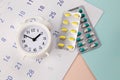 Control Time to take pills. Clock with pills on a monthly calendar Royalty Free Stock Photo