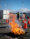 Controlled outdoor fire training with safety barriers and instructor supervision in training yard Royalty Free Stock Photo