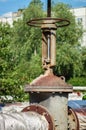 Controlling faucet crane and pipes. Round handle water supply valve close-up. Industrial heating and water supply system Royalty Free Stock Photo