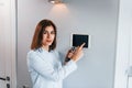 Controlling house by one touch. Young woman is indoors in smart house room at daytime Royalty Free Stock Photo