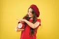 Controlling personal time. Define own rhythm of life. Schedule and time. Set up alarm clock. Child little girl hold red