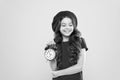Controlling personal time. Set up alarm clock. Child little girl hold red clock. Always on time. It is never too late