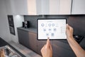Controlling smart devices with a digital tablet on the kitchen Royalty Free Stock Photo