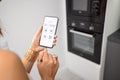 Controlling smart devices with phone on the kitchen Royalty Free Stock Photo