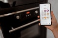 Controlling smart kitchen appliance with mobile application Royalty Free Stock Photo