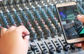 Controls of audio mixing console and phone Royalty Free Stock Photo