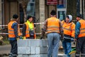 Contruction workers wearing reflective vest preparing for work for repairing street curbs. Bucharest, Romania, 2020