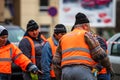 Contruction workers wearing reflective vest preparing for work for repairing street curbs. Bucharest, Romania, 2020