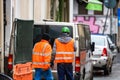 Contruction workers wearing reflective vest preparing for work for repairing street curbs. Bucharest, Romania, 2020