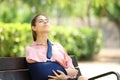 Convalescent woman breathing sitting in a bench