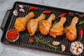 Marinated chicken dramstick on a griddle pan. Top view.Convenience food,pree cooked.Raw chicken for grilling with spices for Royalty Free Stock Photo
