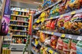 Convenience store alley with chips crisps party snacks and energy drinks, interior detail, inside a small shop, various brands, Royalty Free Stock Photo