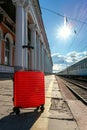 Conveniently positioned travel suitcase by train entrance facilitating easy boarding Royalty Free Stock Photo