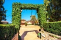 Convento de San Francisco palace from park with green arch in Alhambra. Granada, Andalusia, Spain