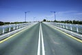 Converging lines of road on bridge