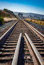 Converging railroad tracks along the ocean coastline Royalty Free Stock Photo