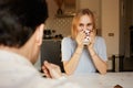 Conversation of confident man and young blond woman at home