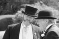 Conversation between two gentlemen with bowler hats in English style in the park Beaulieu in black and white.