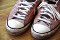 Converse trainers. Popular footwear brand in sneakers and tennis shoes, all star design. Vintage, dirty, worn in pair of cons. Royalty Free Stock Photo