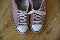 Converse trainers. Popular footwear brand in sneakers and tennis shoes, all star design. Vintage, dirty, worn in pair of cons.