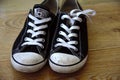 Converse trainers. Popular footwear brand in sneakers and tennis shoes, all star design. Vintage, dirty, worn in pair of cons.