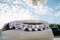 Convertible, cabriolet retro car with balloons and text Just married. Car for groom and bride on country road for honeymoon after Royalty Free Stock Photo