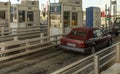 convertible car using pay station on a French motorway near Le Harve Northern France.