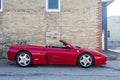 Convertible Ferrari against a brick building
