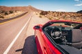 Convertible stopped on a shoulder in desert