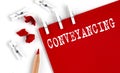 CONVEYANCING text on red paper with office tools on the white background