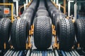 Conveyor belt with aligned tires, each displaying unique tread pattern in production setting