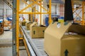 delivery warehouse, with conveyor belt and packing cartons in the foreground